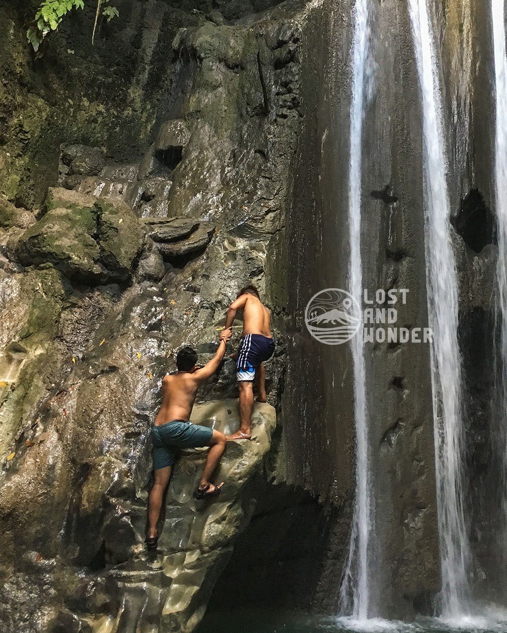 Photo of travelers climbing the Binalayan Falls